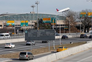 Cars on the Grand Central Parkway pass LaGuardia Airport in New York, Wednesday, Jan. 21, 2015. New York Gov. Andrew Cuomo has proposed a rail link to LaGuardia Airport, one of the busiest airports in the nation.  Cuomo's plan calls for an elevated AirTrain connecting the airport with the Willets Point station 1.5 miles away. The station, opposite the Mets' ballpark, serves both the Long Island Rail Road commuter rail and the No. 7 subway line.  (AP Photo/Kathy Willens)